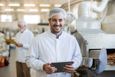 Uomo con tablet che effettua un controllo igienico con gli indicatori di contaminazione microbica schülke