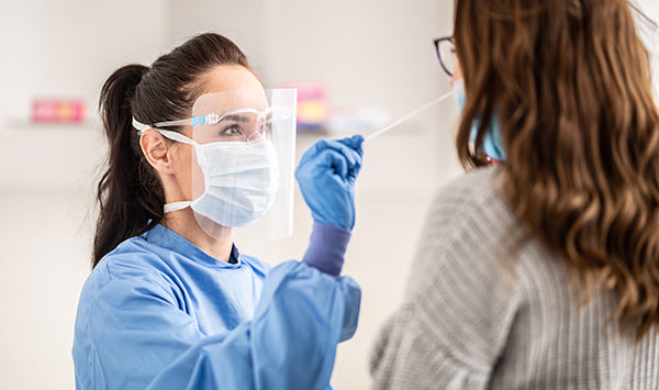A woman performs a Corona PCR test